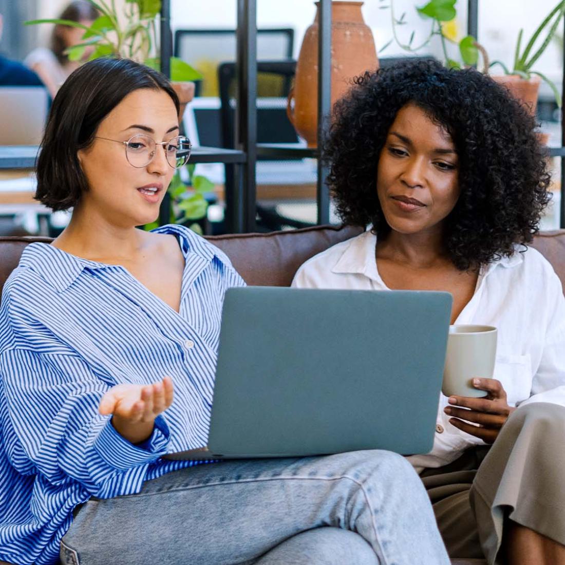 image of two women looking at a laptop